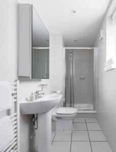 a bathroom with a sink, toilet and shower at SACO Holborn – Lamb’s Conduit St in London