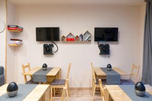 a dining room with wooden tables and a tv at Snowake House in Castel di Sangro