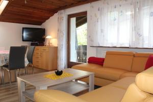 a living room with a couch and a table at Haus Ganahl in Vandans