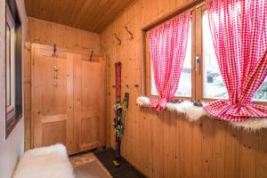 een kamer met rode en witte gordijnen en een raam bij Landhaus Eder in Kirchberg in Tirol