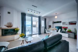 a living room with a couch and a fireplace at Seafront Suites Maja in Vis