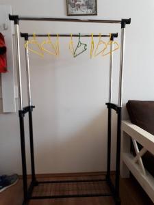a metal stand with hangers on a wall at EP Apartment in Mgzavrebi Bakuriani in Bakuriani
