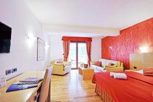 a hotel room with a bed and a living room at Vilola in Umag