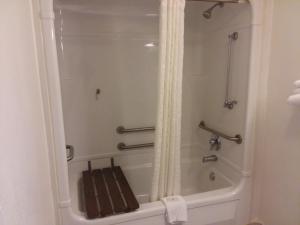 a shower in a bathroom with a bath tub at Knights Inn Burlington NC in Burlington +23 photos