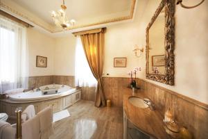 a bathroom with a tub and a sink and a mirror at Villa Castiglioni Luxury Apartment in Laglio +93 photos