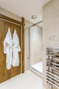 a bathroom with white towels hanging on a door at The Cow Dalbury in Dalbury Lees