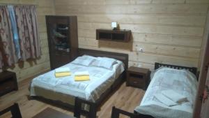 a bedroom with two beds and a tv on the wall at Wanta in Bukowina Tatrzańska