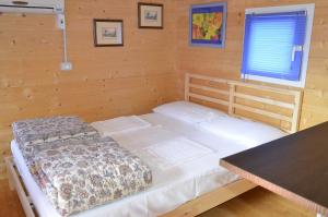 a bedroom with a bed in a wooden room at Camping Adamello in Edolo