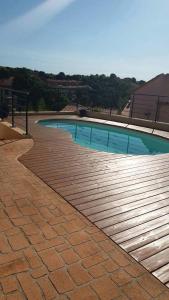 a swimming pool on a brick walkway next to a building at Les hauteurs de Collioure in Collioure