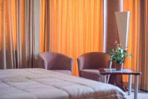 Postel nebo postele na pokoji v ubytování Perla Hotel