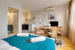a bedroom with a bed and a table with a desk at Quality Point Apartments 0-24 reception in Budapest