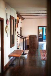 a living room with a wooden bench and stairs at Troutbeck in Amenia