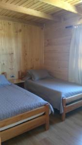 Postel nebo postele na pokoji v ubytování HelChiloé Cabañas