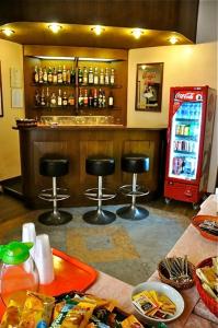 a bar with two stools and a soda machine at Hotel Vecchia Milano in Milan