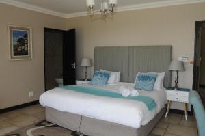 a bedroom with a large bed with towels on it at Hilken Lodge in Durban +21 photos