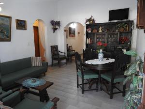 a living room with a couch and a table and chairs at La Loberia - Las Grutas in Las Grutas