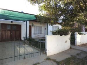 a house with a gate and a fence at La Loberia - Las Grutas in Las Grutas