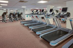 a gym with a row of tread machines at Westford Regency Inn & Conference Center in Westford