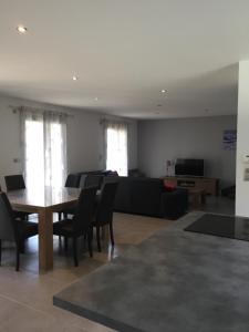 a living room with a table and a couch at Villa MARIA in Chambon-sur-Lac
