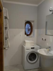 a bathroom with a washing machine and a sink at Na Prusa in Szklarska Poręba