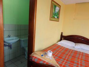Ein Bett oder Betten in einem Zimmer der Unterkunft Hostal Miraflores Cayambe