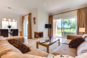 a living room with two couches and a fireplace at Arcos Gardens Sol Rent Golf in Arcos de la Frontera