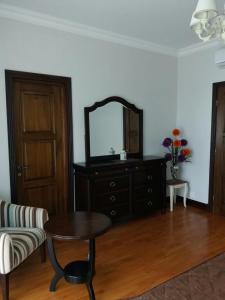 a living room with a table and a mirror at Castle in Makhinjauri