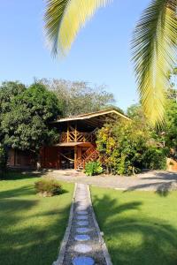 a house with a stone path in front of it at Casa Margarita in Puerto Viejo