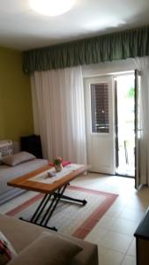 a living room with a table in front of a door at Apartments Šorić in Rovinj