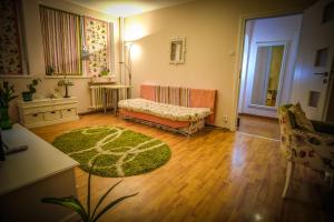a living room with a couch and a green rug at Mozaic Home in Bucharest