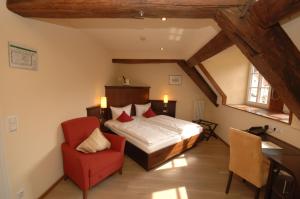 En eller flere senge i et værelse på Hotel Restaurant Ölmühle