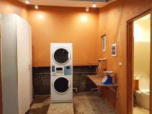 a bathroom with a washer and dryer in it at Stay Amare Villa Maria 2 in Bacolod