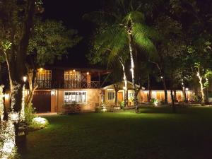 a house with lights in the yard at night at Stay Amare Villa Maria 2 in Bacolod