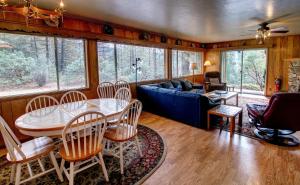a living room with a table and a blue couch at 17A Longview in Wawona