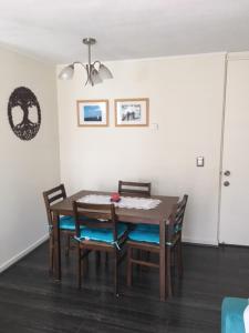 a dining room with a wooden table and chairs at Apart & Tour in Puerto Varas