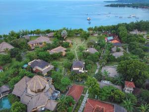 an aerial view of a house with the water at Taman Sari Bali Resort and Spa in Pemuteran