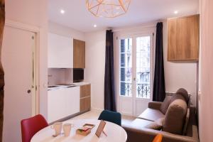 a small living room with a table and a couch at Baps Apartaments 2 in Bilbao