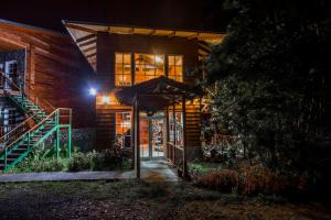 a building with an open door at night at Hotel Bosque Verde Lodge in Monteverde Costa Rica