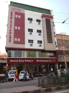 a hotel city palace with people walking in front of it at Hotel City Palace in Jodhpur