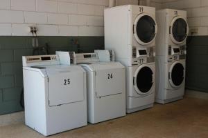 four washers and dryers are lined up in a room at BIG4 Howard Springs Holiday Park in Darwin