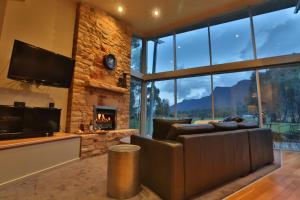 a living room with a couch and a fireplace at Bushland in Halls Gap