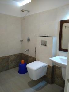 a bathroom with a toilet and a sink at Highrange Plaza in Thekkady
