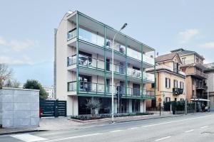 an apartment building on the side of a street at La Perla by Sedar in Como