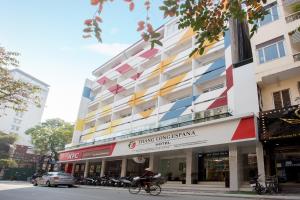 a building with a colorful facade on a city street at Thang Long Espana Hotel in Hanoi