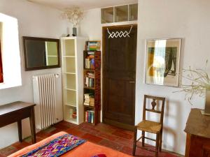 a living room with a book shelf and a door at CASA LEONE - Apartements im Alto Malcantone in Breno