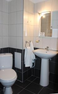 a bathroom with a toilet and a sink at Family Hotel Silistra in Silistra