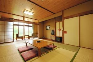 a living room with a coffee table in a room at Horohoro Sanso in Date