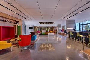 a lobby with colorful chairs and tables in a building at Haifa Bay View Hotel in Haifa
