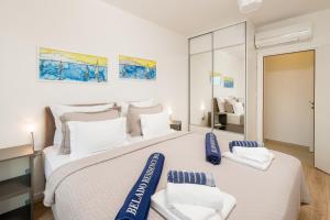 a bedroom with a large white bed with blue pillows at Belado Residence Bol in Bol