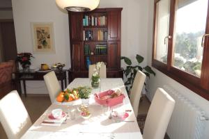 a dining room with a table with a bowl of fruit at La Terrazza in Oristano